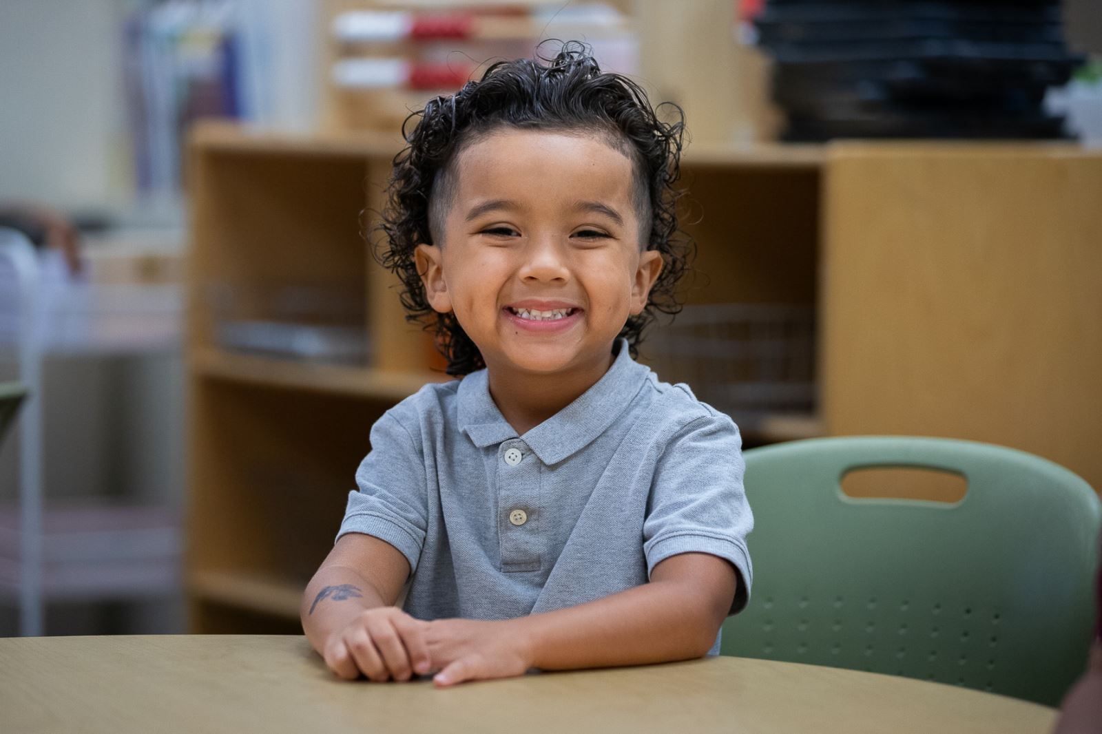 A young boy smiles excitedly about the first day of school at Grijalva Elementary.