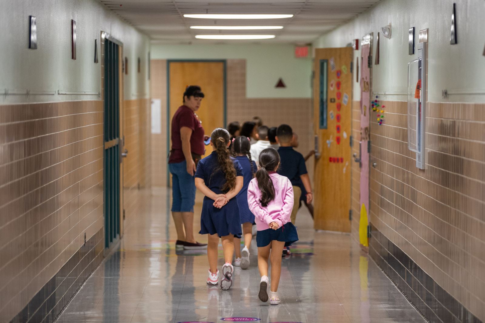 Grijalva Elementary students wait in the hallway outside their classroom on the first day
